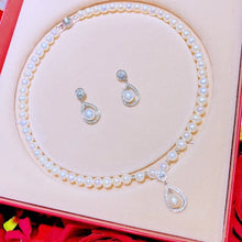silver and pearl necklace and earring set